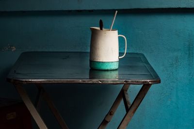 Close-up of drink on table against wall