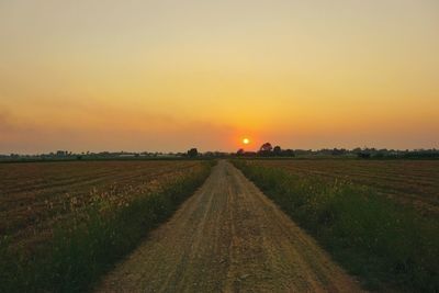 Scenic view of field against sky during sunset