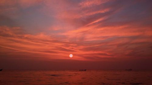 Scenic view of sea against romantic sky at sunset