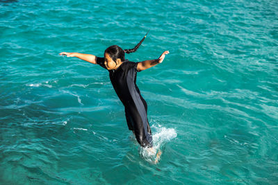 Girl diving in sea