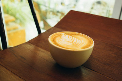 Close-up of cappuccino on wooden table