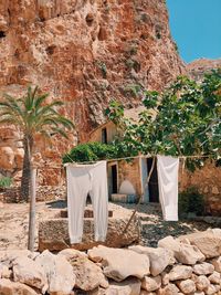 Clothes drying on rock against stone wall