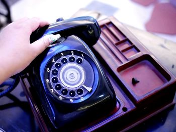 Close-up of woman using vintage telephone