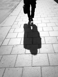 Shadow of people on footpath