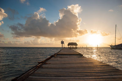 Pier on sea during sunset
