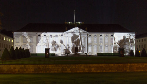 Statue in city at night