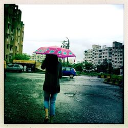 Woman walking on road in city