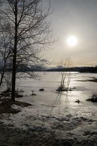 Scenic view of frozen lake against sky during winter
