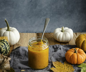 Close-up of pumpkin and drink on table