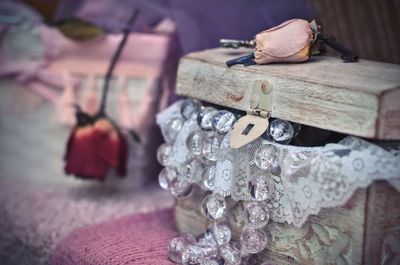 Close-up of bead necklace in treasure chest on table