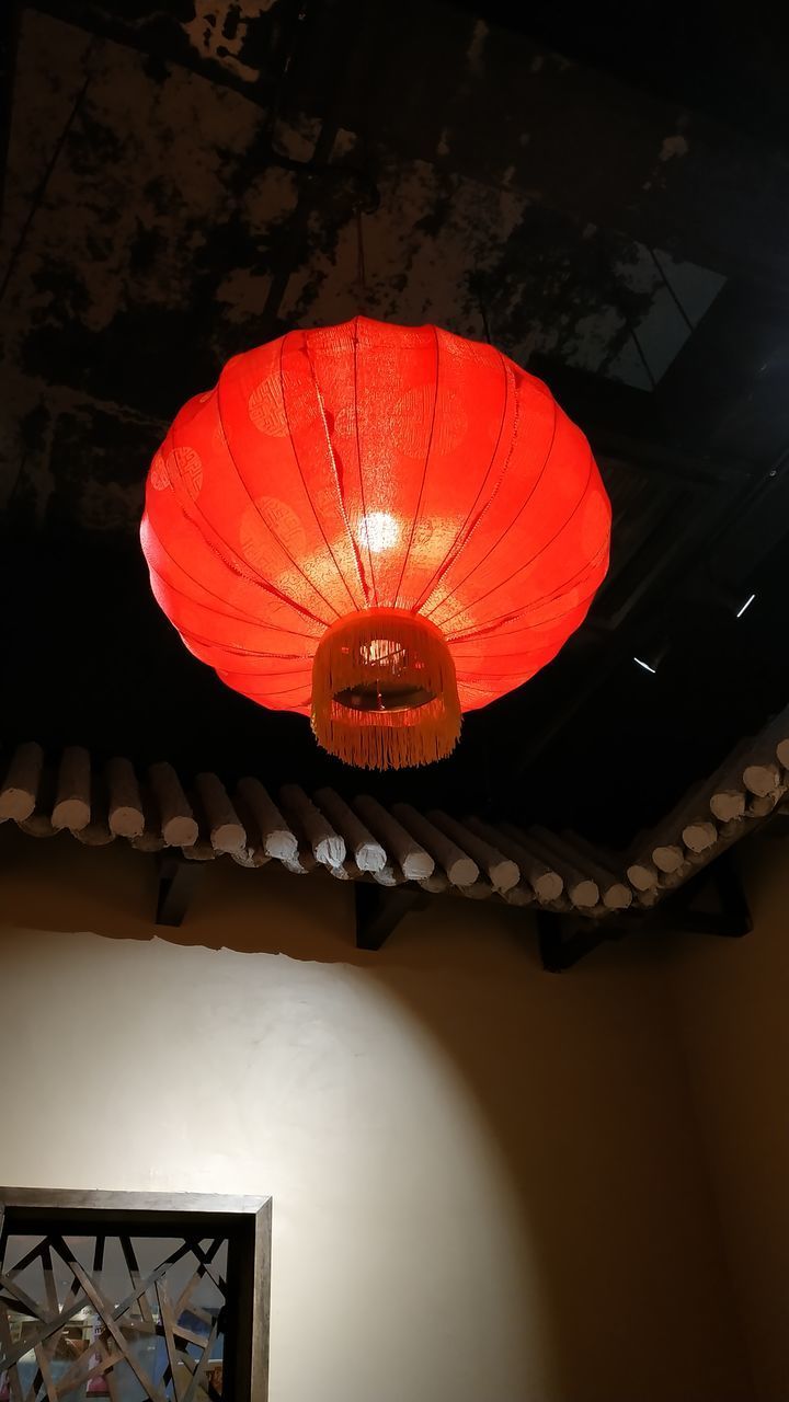 LOW ANGLE VIEW OF ILLUMINATED LANTERNS HANGING IN CEILING