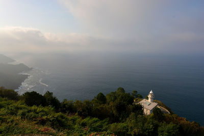 High angle view of buildings by sea against sky