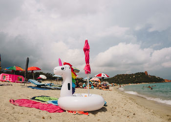 Toy on beach against sky