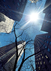 Low angle view of modern building against sky on sunny day