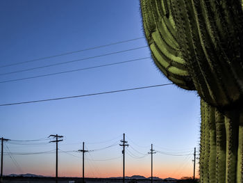 Low angle view of electricity pylon against sky