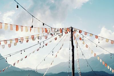Low angle view of flags against sky