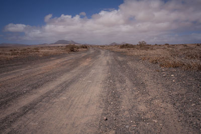 Road on desert against sky