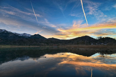 Scenic view of lake against sky during sunset