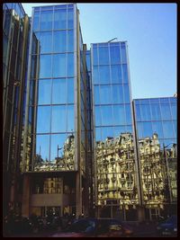 Low angle view of modern building against blue sky