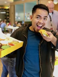 Portrait of smiling man holding ice cream