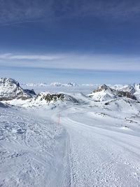 Scenic view of snow covered landscape against sky