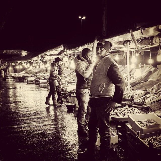 men, lifestyles, water, leisure activity, built structure, night, rear view, full length, standing, architecture, building exterior, casual clothing, illuminated, river, togetherness, person, boys