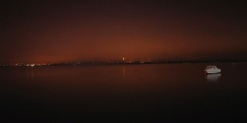 Scenic view of sea against clear sky at night