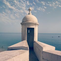 View of building by sea against sky