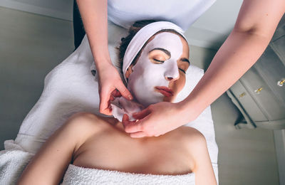 Massage therapist treating customer at spa