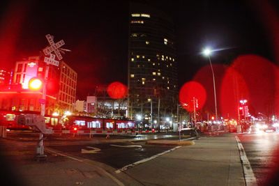 Illuminated city street and buildings at night