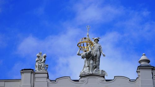 Low angle view of statue against cloudy sky