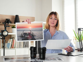 Portrait of young woman using laptop at home