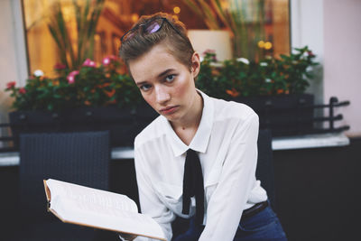 Businesswoman using laptop while sitting on table