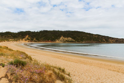 Scenic view of beach lagoon against sky