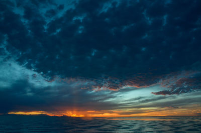 Scenic view of dramatic sky over sea during sunset