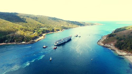 High angle view of boats on sea shore against sky