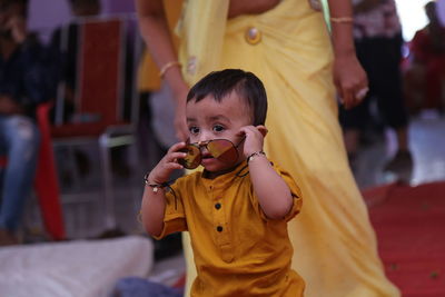Full length of a boy holding yellow