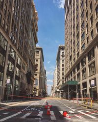 View of city street and buildings against sky