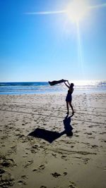 Full length of man on beach against clear sky