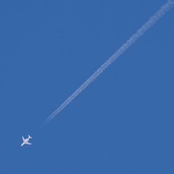 Low angle view of airplane flying in sky