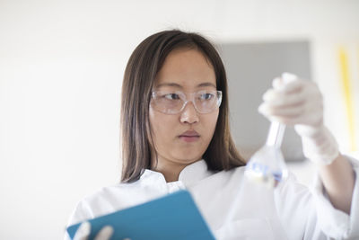 Scientist female with lab glasses and tablet in a lab