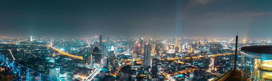 High angle view of illuminated city buildings at night