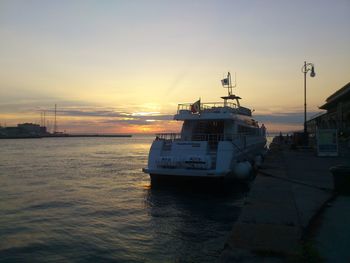 Boat sailing in sea against sky during sunset