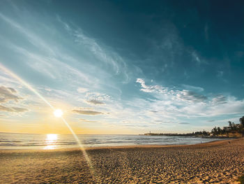 Scenic view of beach against sky during sunset