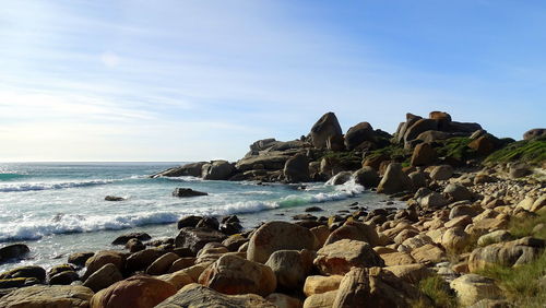 Rocks on beach against sky