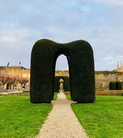 Stone structure on field against sky