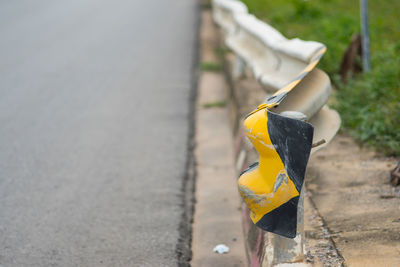 Close-up of yellow umbrella on roadside