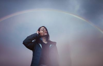 Full length of a young man in rainbow