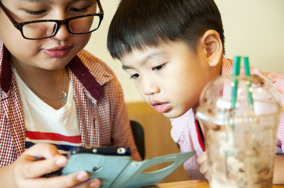 Close-up of boy looking at smart phone