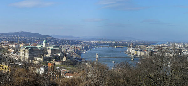 High angle view of city by sea against sky